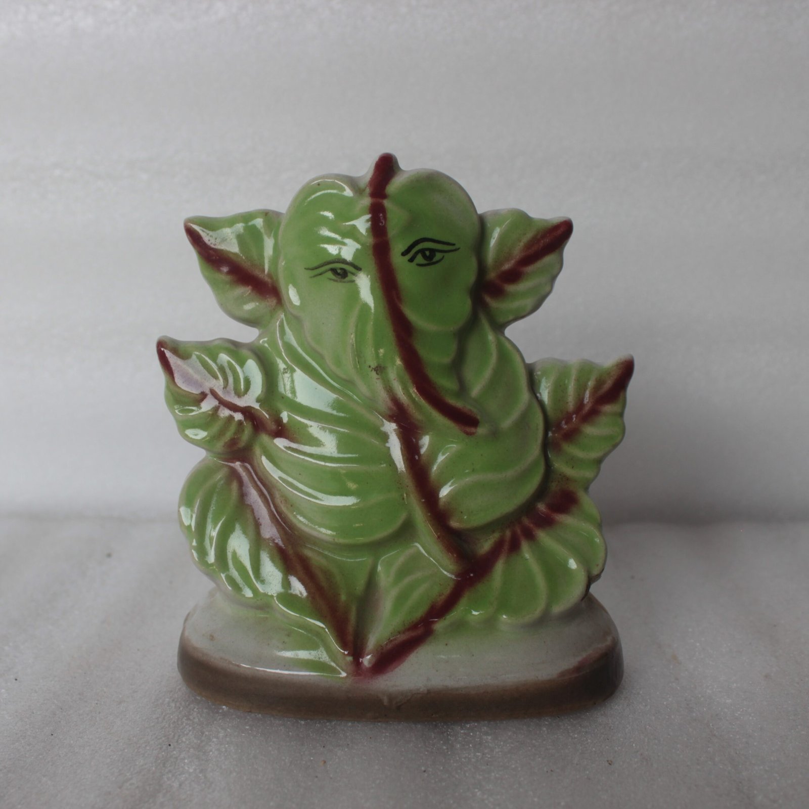 BW-55-1-scaled-1.jpg Leaf-Inspired Ceramic Ganesh Ji Idol – Green Porcelain Hindu God Statue, Home Decor - Image 1